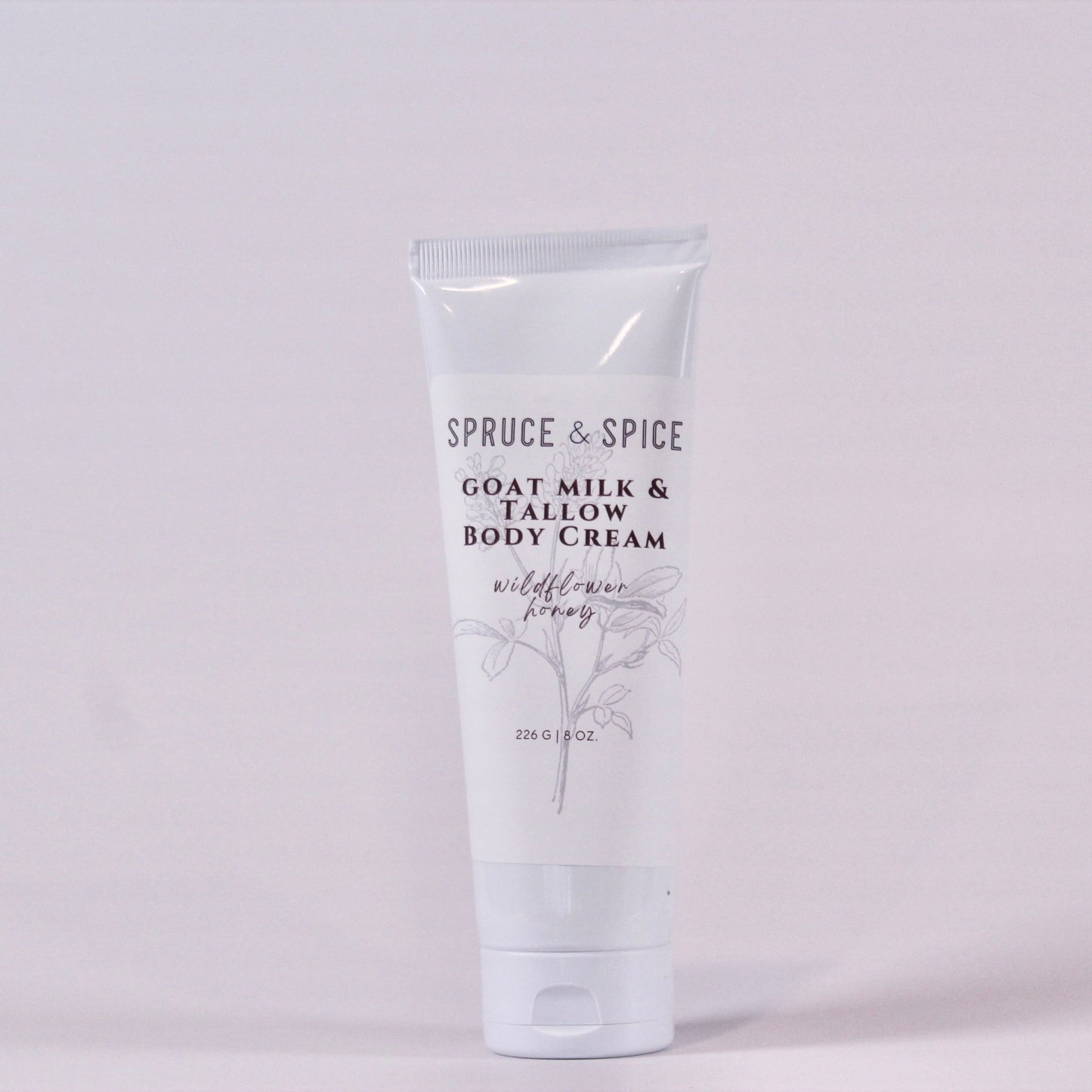 Body cream tube labeled 'Spruce & Spice' on a white background
